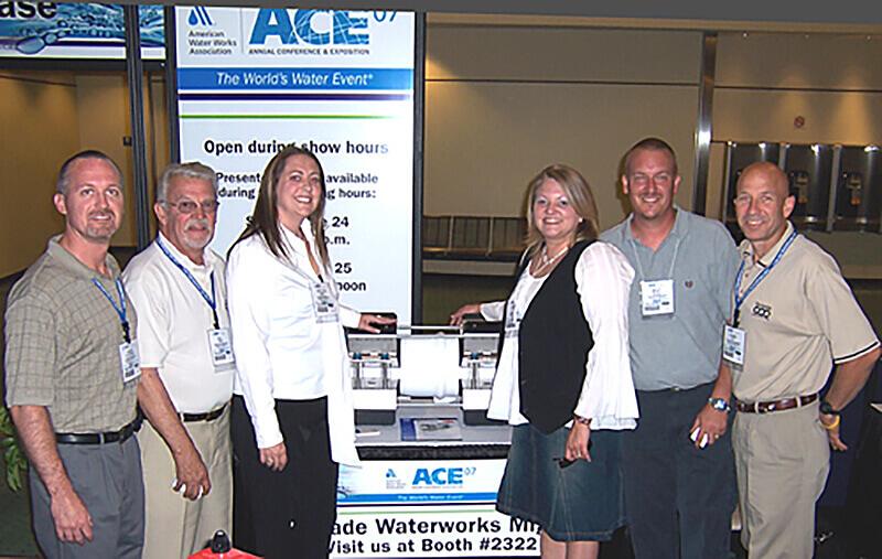 Cascade Employees standing by a booth at a trade show